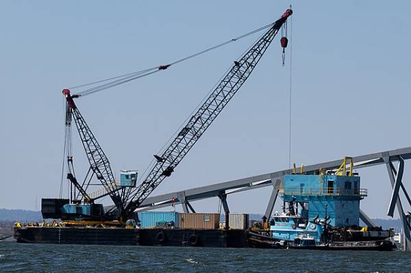 Two crane barges, one that's 650 tons and another that's 330, are on the scene as workers clean up debris.

