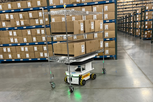 A mobile robot moves a racking system around a DHL warehouse in Columbus, Ohio. Automation is being used to upskill and retain the current workforce, but it is also being deployed to fill critical labor gaps that continue to grow, up 30% in 2023.