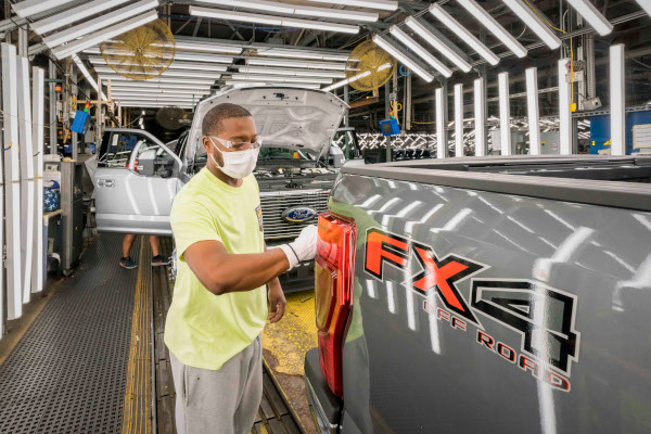 A Ford worker polishes a truck at the end of the assembly line. An extended United Auto Workers strike against the Big 3 automakers could have significant ripple effects in the automotive supply chain, hampering smaller manufacturers and related suppliers. 